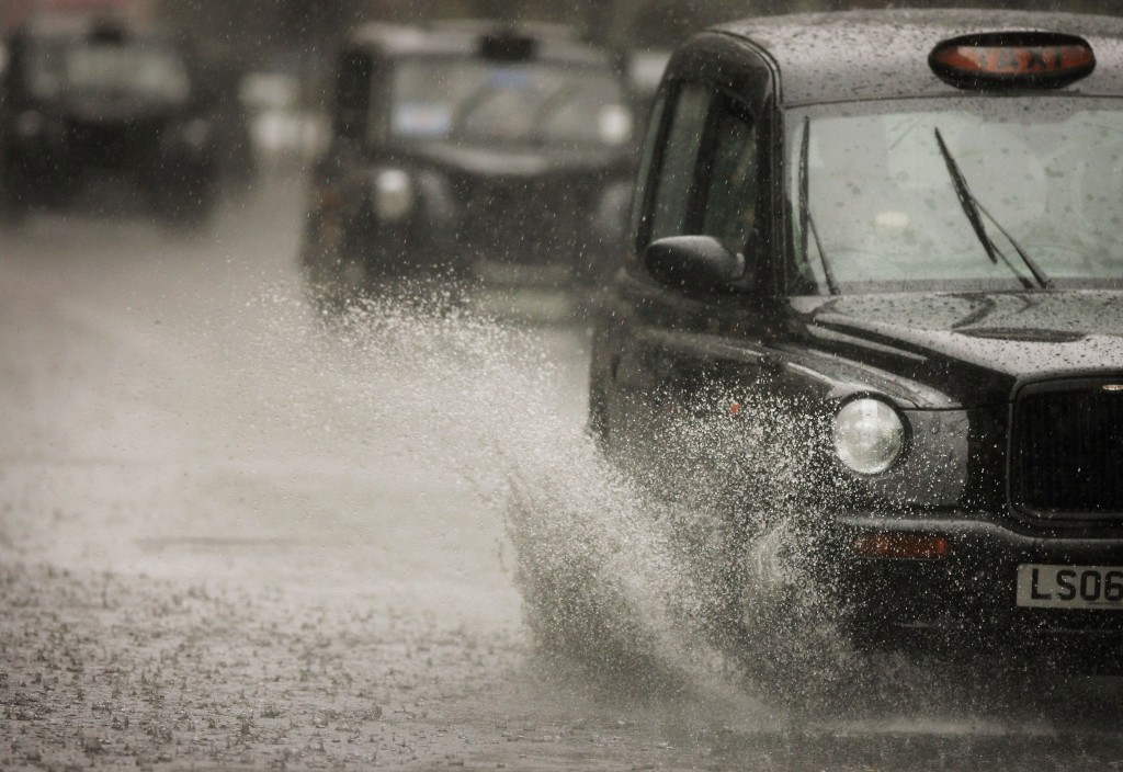LONDON - JUNE 13: A London "Black Cab" taxi drives through a patch of standing water after a heavy downpour on June 13, 2006 in London. (Photo by Bruno Vincent/Getty Images)