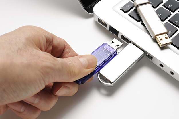 Isolated shot of connecting USB flash drive on white background