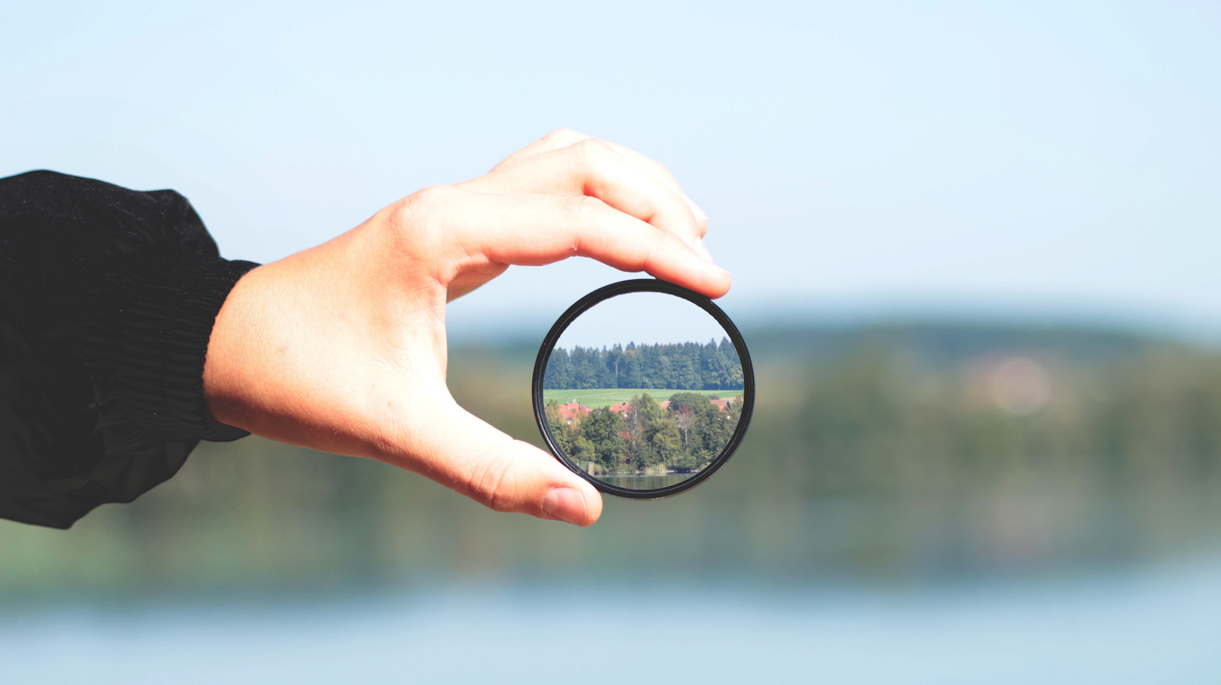 Cropped Hand Holding Lens With Reflection Cropped Hand Holding Lens With Reflection