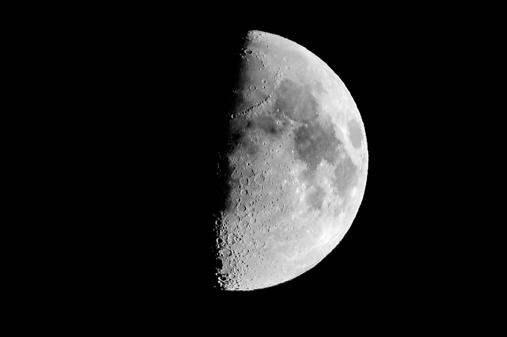 Foto da Lua com metade do satélite escuro e metade iluminado.