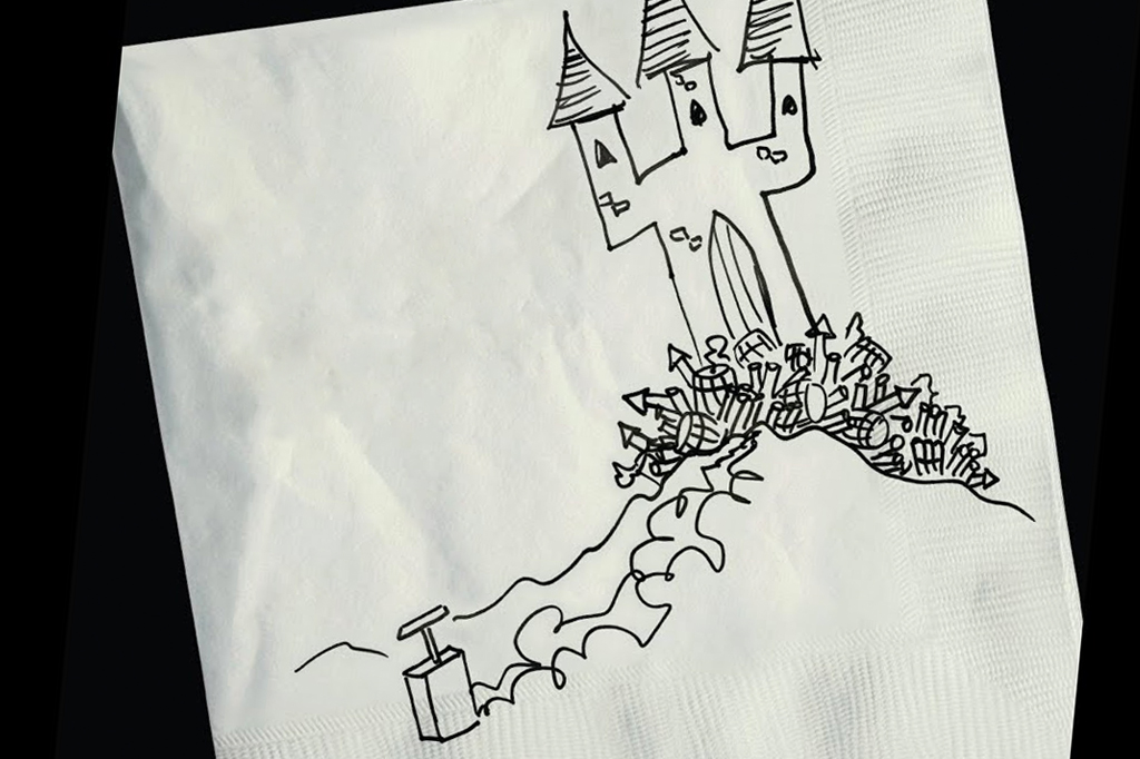 A imagem mostra um guardanapo branco com a ilustração de um castelo cercado de fogos de artifícios ligados a um detonador. A ilustração é feita em caneta preta e o fundo da imagem também é preto.
