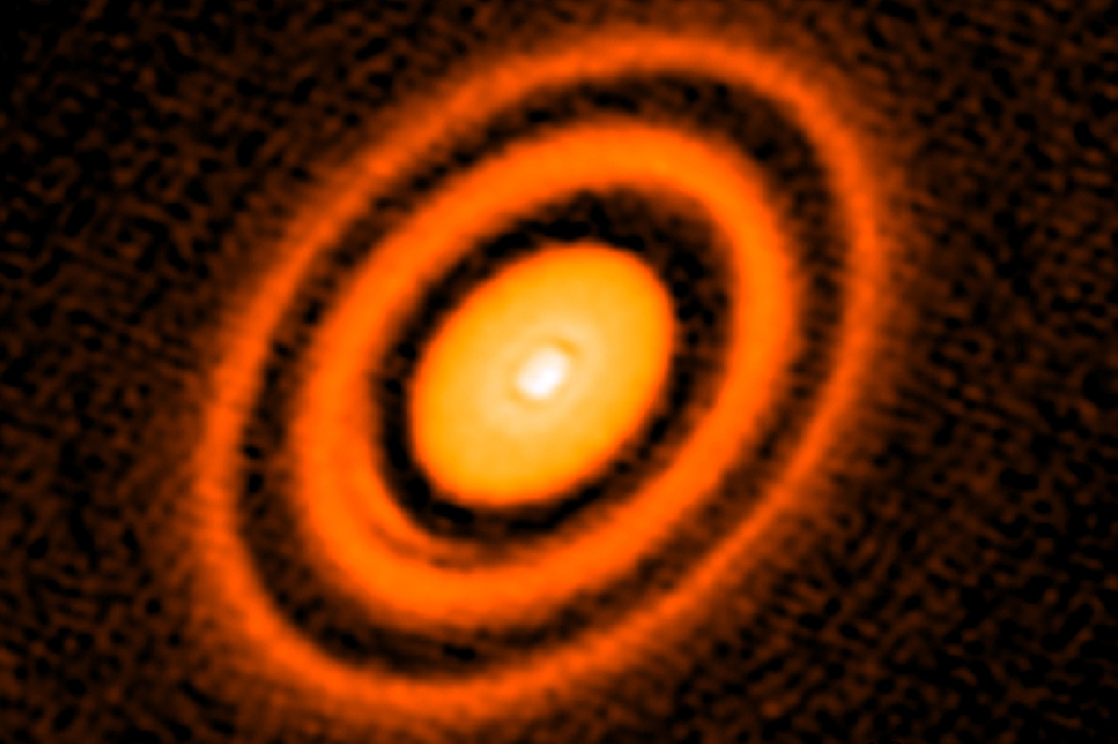 Imagem da jovem estrela HD163296 com aneis ao seu redor.