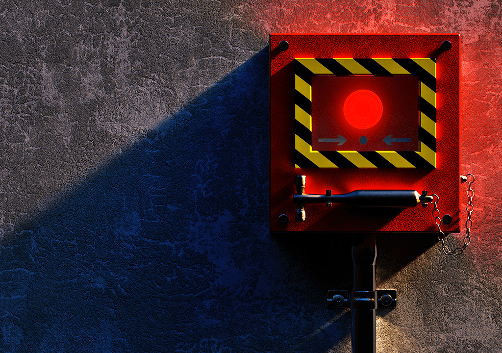 Foto de um botão vermelho protegido por uma caixa de acrílico.