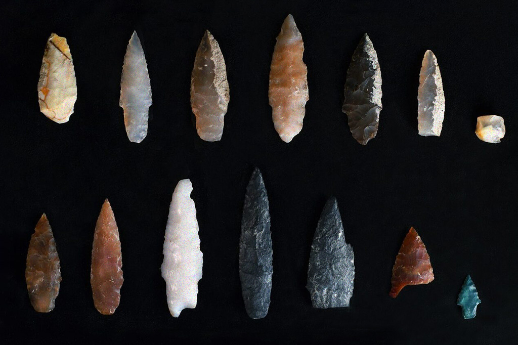 Foto mostrando diversas pontas de dardo de vários tamanhos, cores e formatos diferentes.