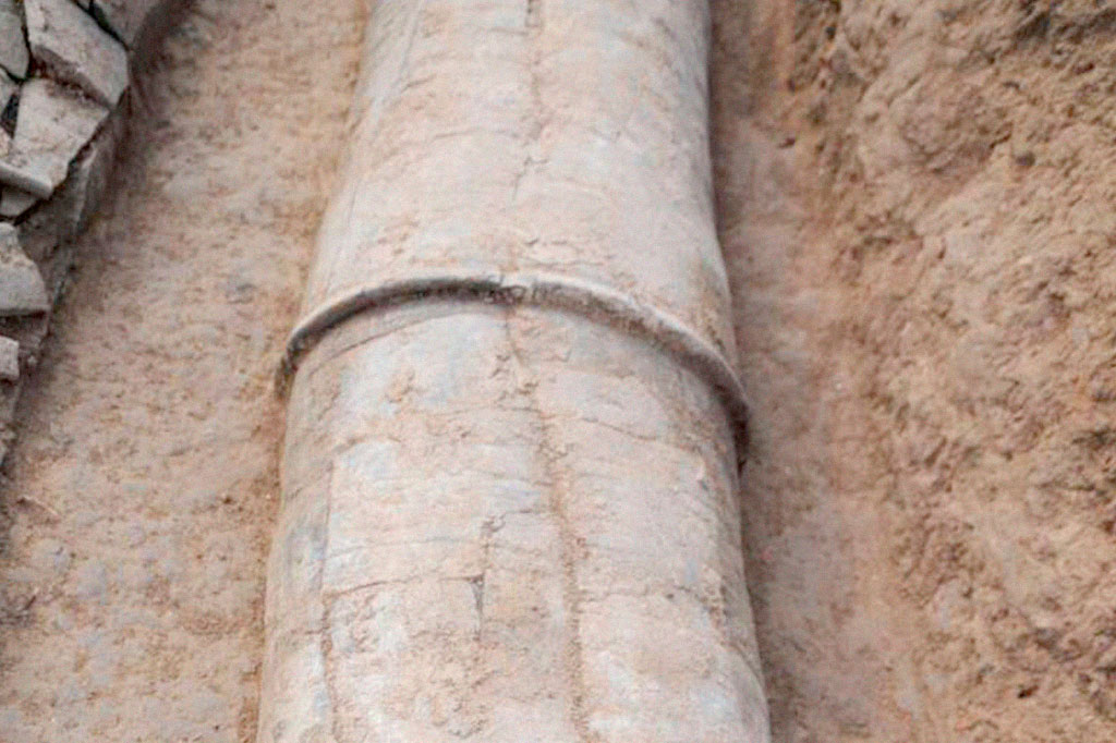 Closeup photo of water pipe segments fitted together in situ at Pingliangtai.