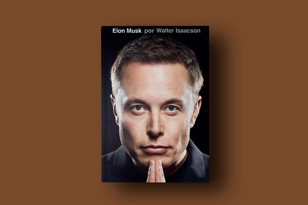 Foto do livro biográfico de Elon Musk sob fundo marrom liso.