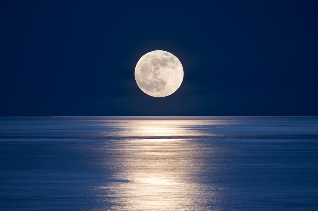 Lua cheia acima do mar.