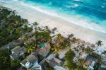 Fotografia aérea de casas perto do mar, na região de Tulum, México.