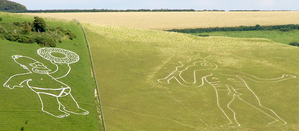 Fotografia do Homer Simpson como promo&ccedil;&atilde;o para o filme Os Simpsons ao lado do Gigante de Cerne Abbas, um monumento milenar com um p&ecirc;nis de 8 metros na Inglaterra.