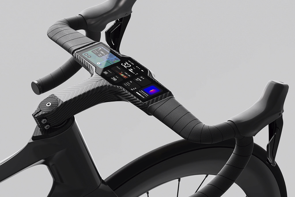 Imagem, em fundo cinza, de um guidão de bicicleta com painel digital.